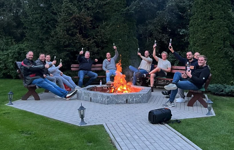MAGO guests relaxing together by the campfire
