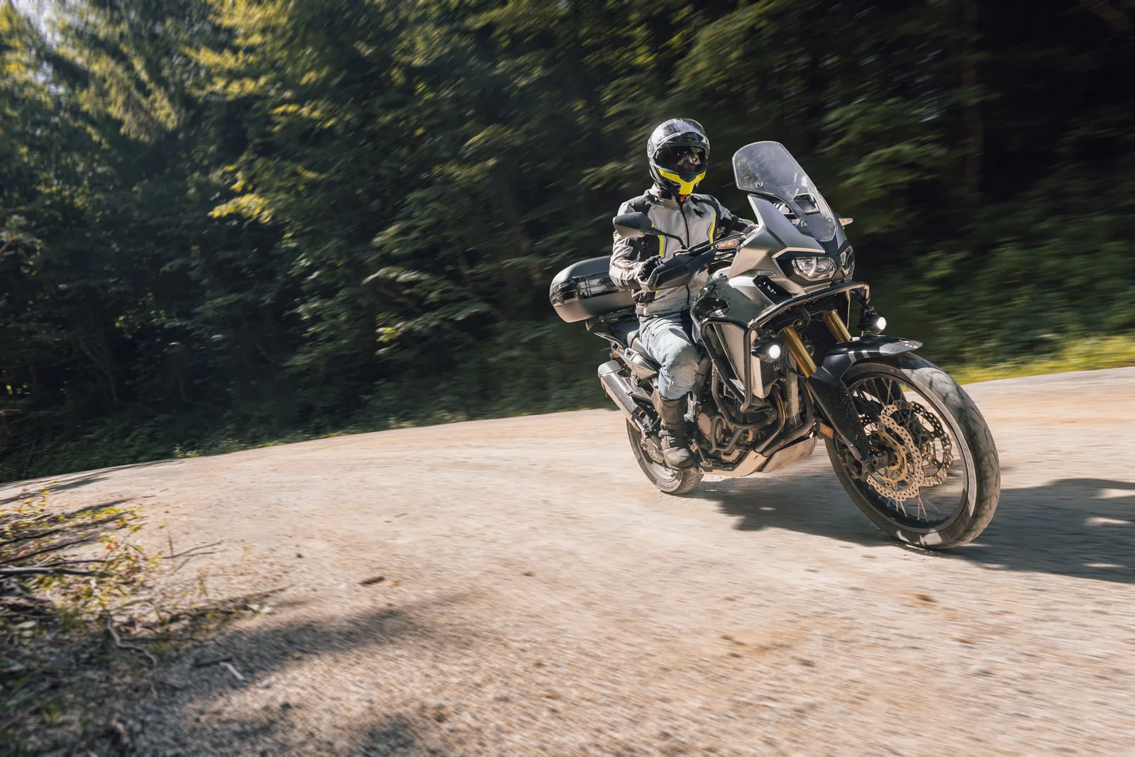 Motorcyclist on a gravel road in the forest
